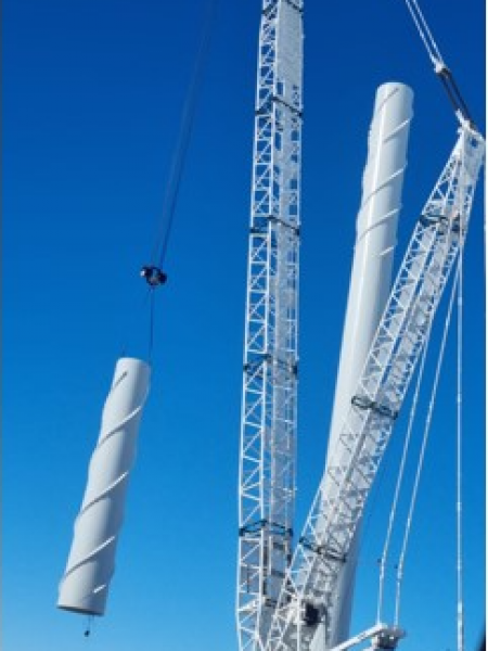 Installation team assembling a wind turbine at a wind farm site, facilitating the growth of renewable energy production.